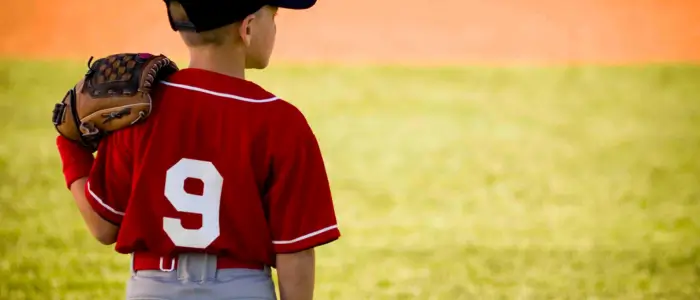 a young boy in a custom baseball jersey