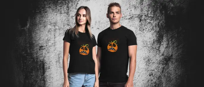 couple in black shirts with a pumpkin image - halloween costume ideas