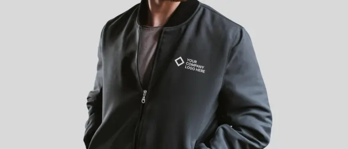 a man wearing a black custom bomber jacket featuring a logo