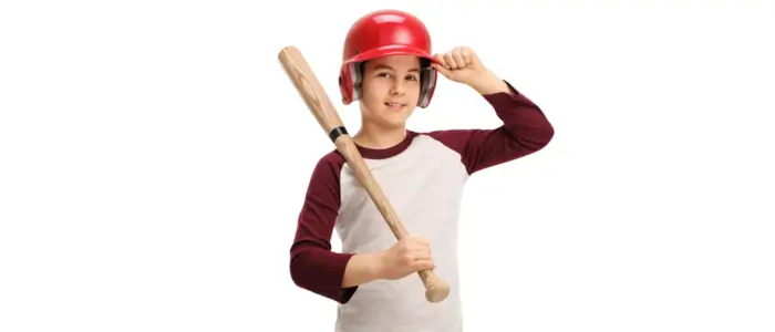 a young baseball player in a helmet, holding a bat and wearing a customized baseball jersey shirt