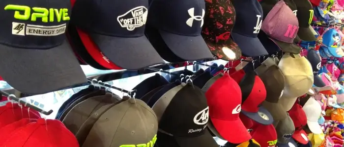 collection of embroidered hats showcased on a rack