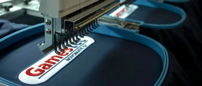 embroidery process showing machine sewing logo onto shirt