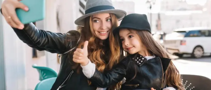 a woman and her daughter smiling while taking a selfie, celebrating mother’s day gifts