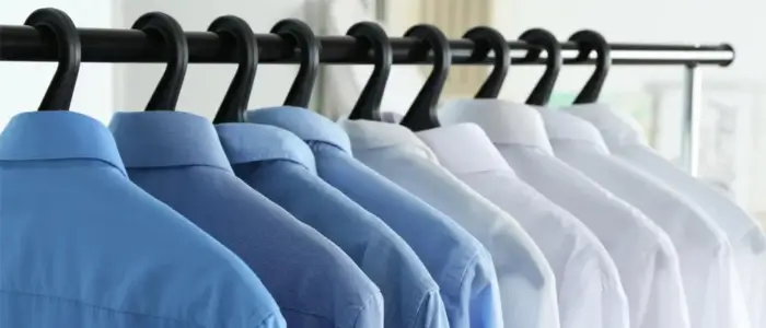 port authority wholesale shirts displayed on a clothes line rack