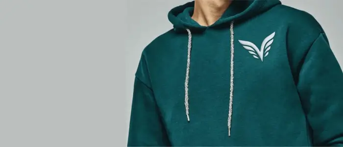 man in custom embroidered green hoodie with white logo