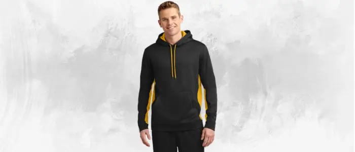 a man wearing a black and yellow sport-tek sport-wick fleece hooded pullover