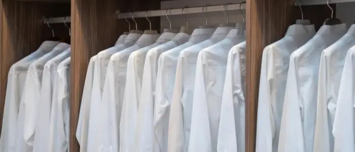 formal white shirts displayed on a closet rack