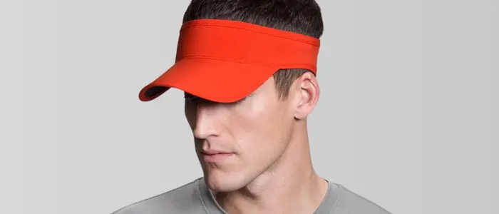 a man wearing an orange visor hat