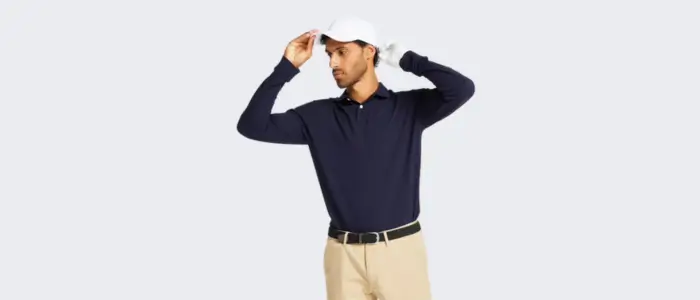  a man wear a blue long sleeve polo shirt and a white hat