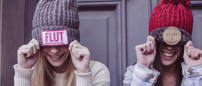 two women wearing beanies caps