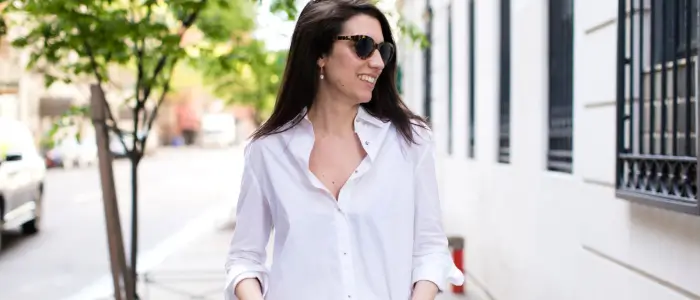  a woman in white button-down shirt and jeans