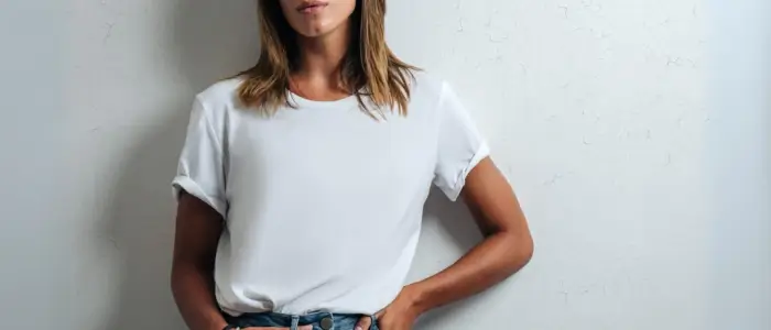 a woman wearing a white crew neck t-shirt and jeans