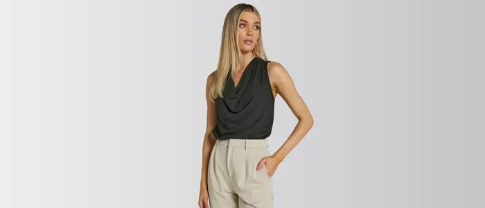 woman in black top and beige pants with cowl