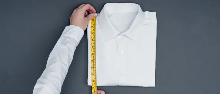 a person measuring a shirt size