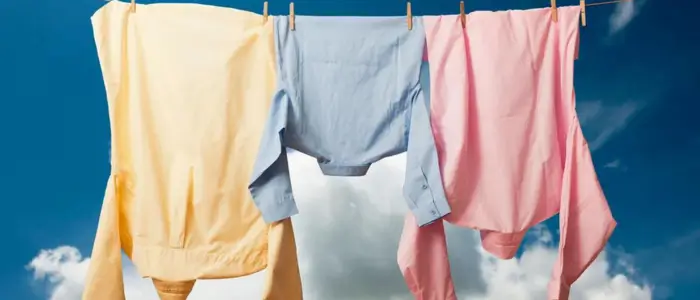  colorful cotton shirts drying on a clothesline