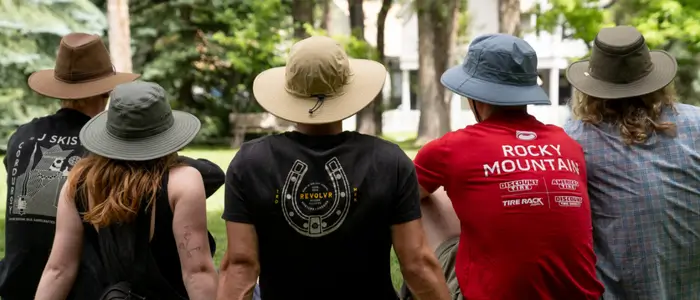 a group of people wearing sun hats