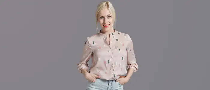 a woman in a pink blouse and jeans