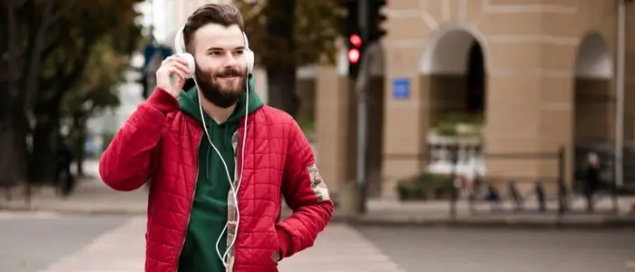 a man wearing a red bomber jacket